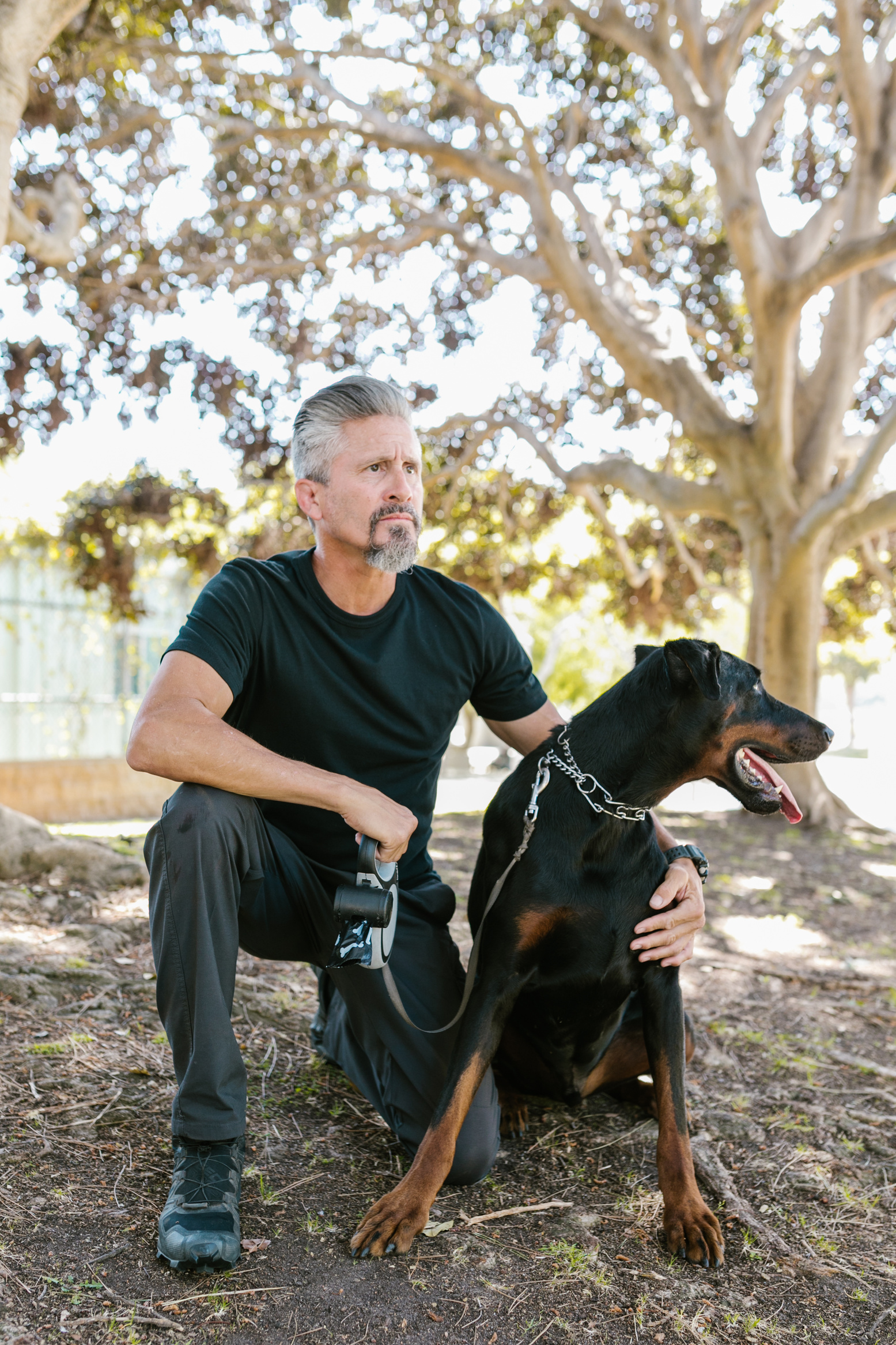 Person Holding a Dog While Crouching